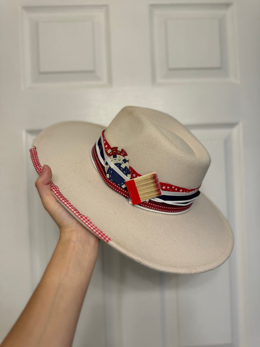 The American Hat “ I’ll put a boot in your … it’s the American Way”